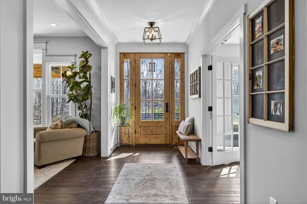 a view of a hallway with wooden floors and stairs