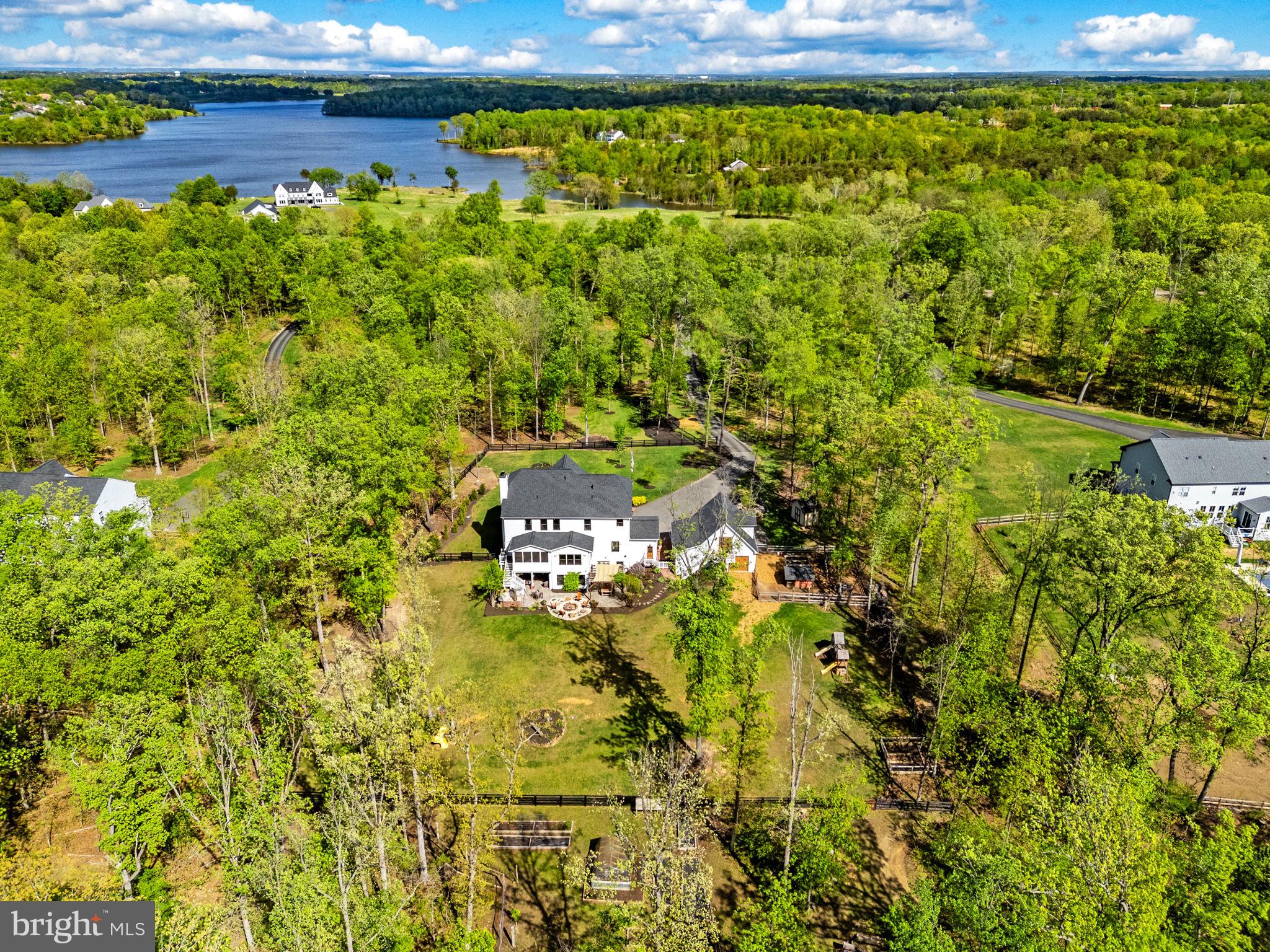 8794 Buckland Mill Road Gainesville, VA 20155 - Photo 63 of 67 Serene lakeside retreat in lush greenery.