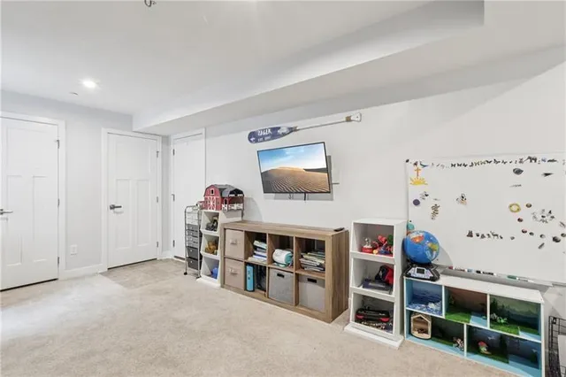 a living room with furniture and a flat tv screen