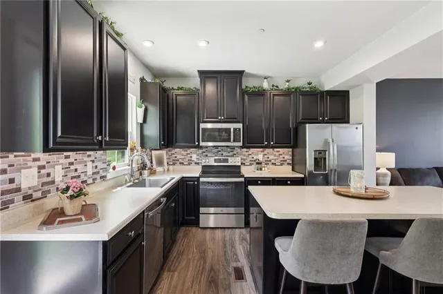 a large kitchen with a table and chairs
