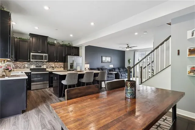 a living room with lots of furniture and kitchen view
