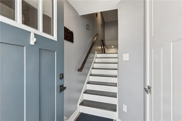 a view of staircase with lots of frames on wall