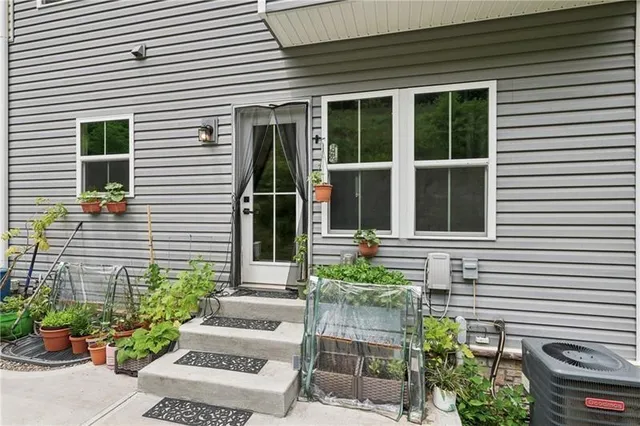 a view of a house with potted plants