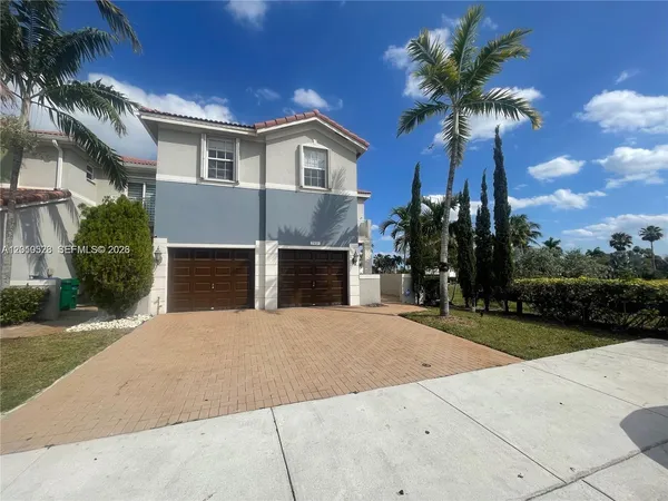 a front view of a house with a yard and garage