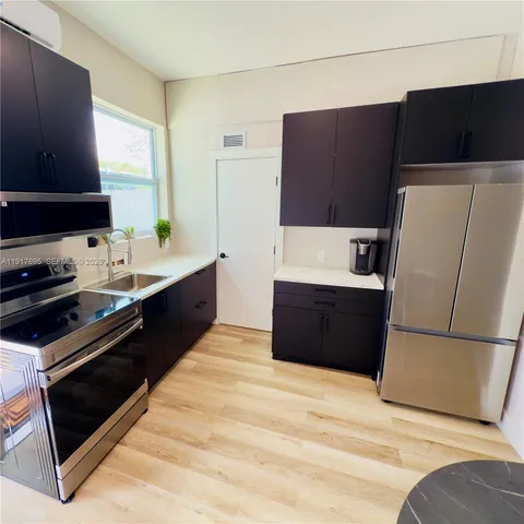 a kitchen with a refrigerator and a sink
