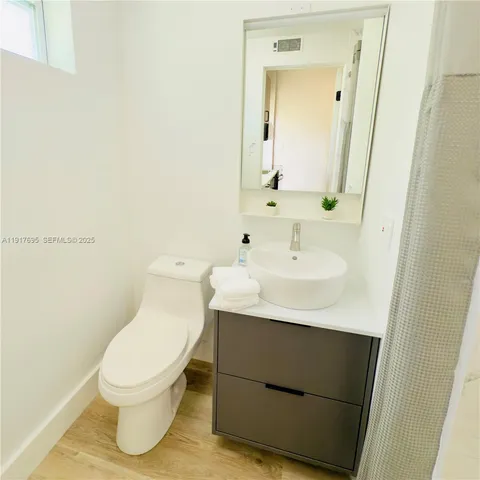 a bathroom with a sink toilet and mirror