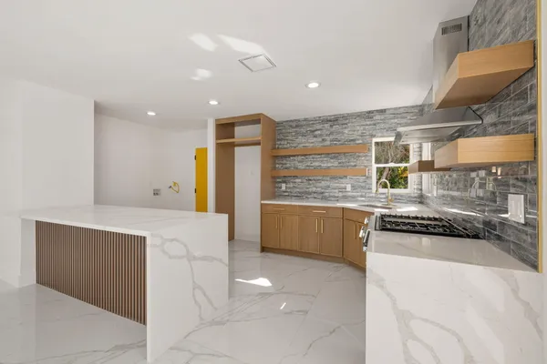 a kitchen with stainless steel appliances a stove sink and cabinets