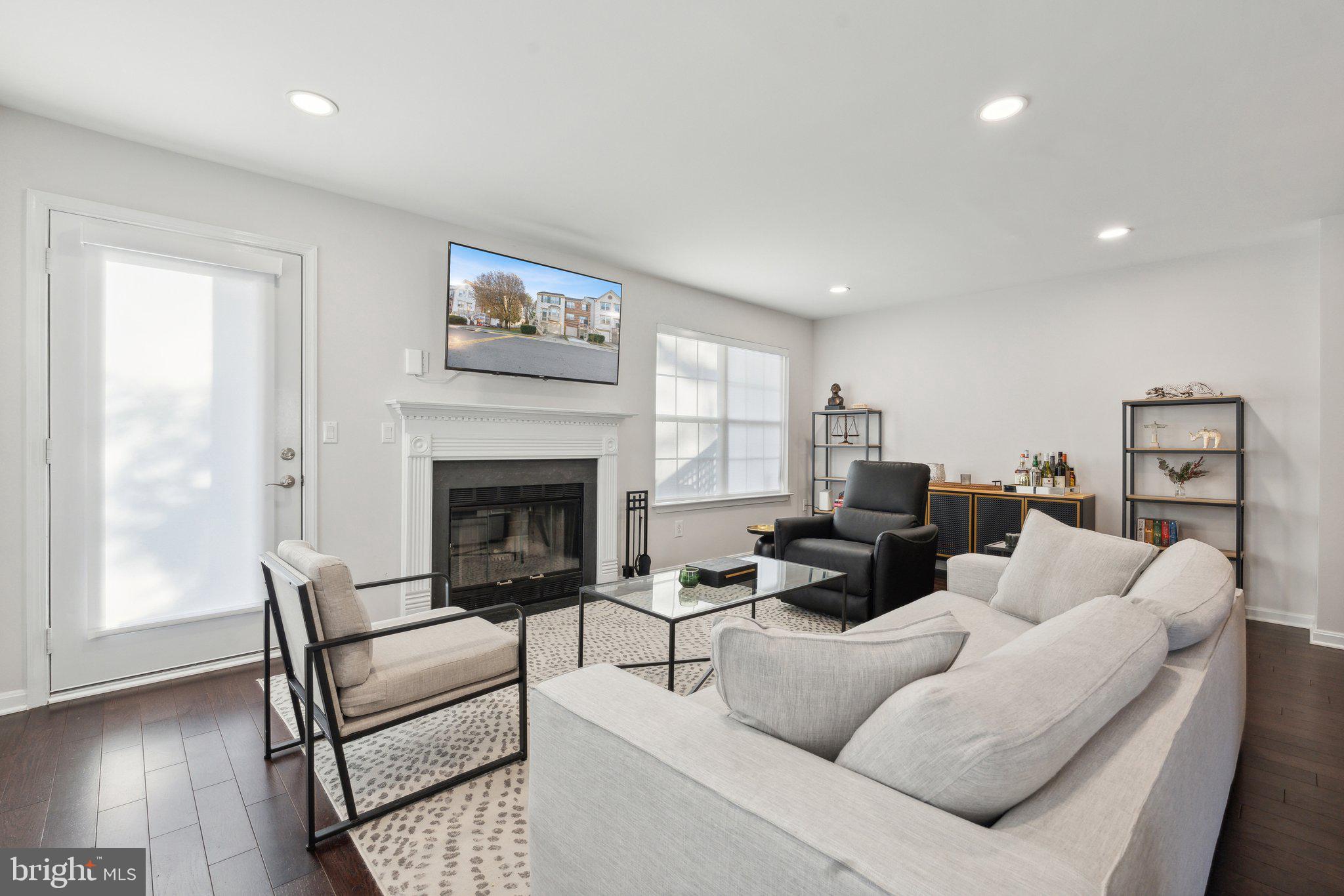 410 McDaniel Drive Purcellville, VA 20132 - Photo 17 of 36 a living room with furniture a large window and a fireplace