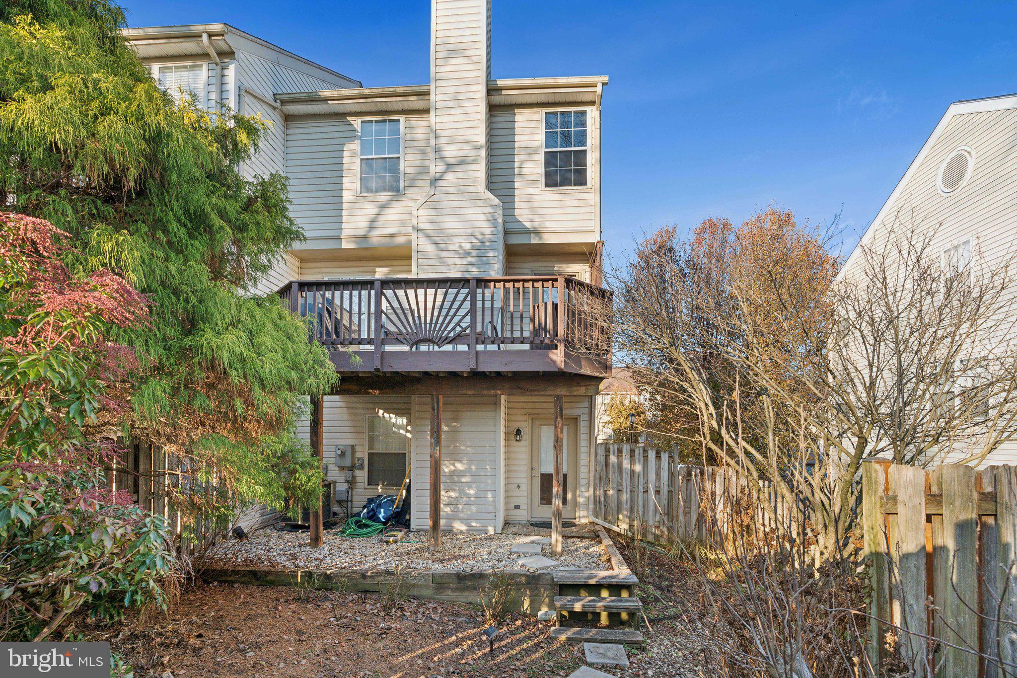 410 McDaniel Drive Purcellville, VA 20132 - Photo 2 of 36 a view of a brick house with windows and wooden fence