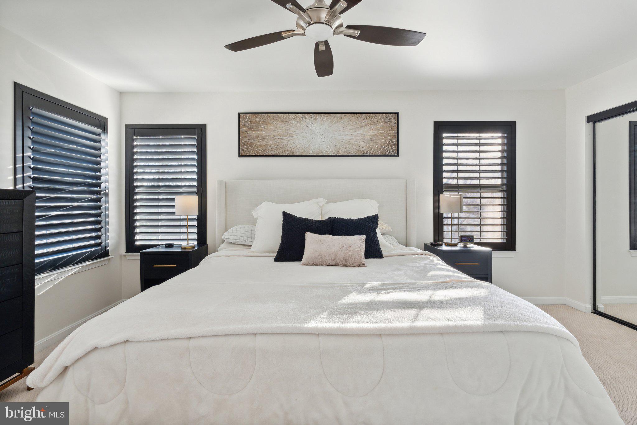 410 McDaniel Drive Purcellville, VA 20132 - Photo 22 of 36 a bedroom with a large bed and a chandelier