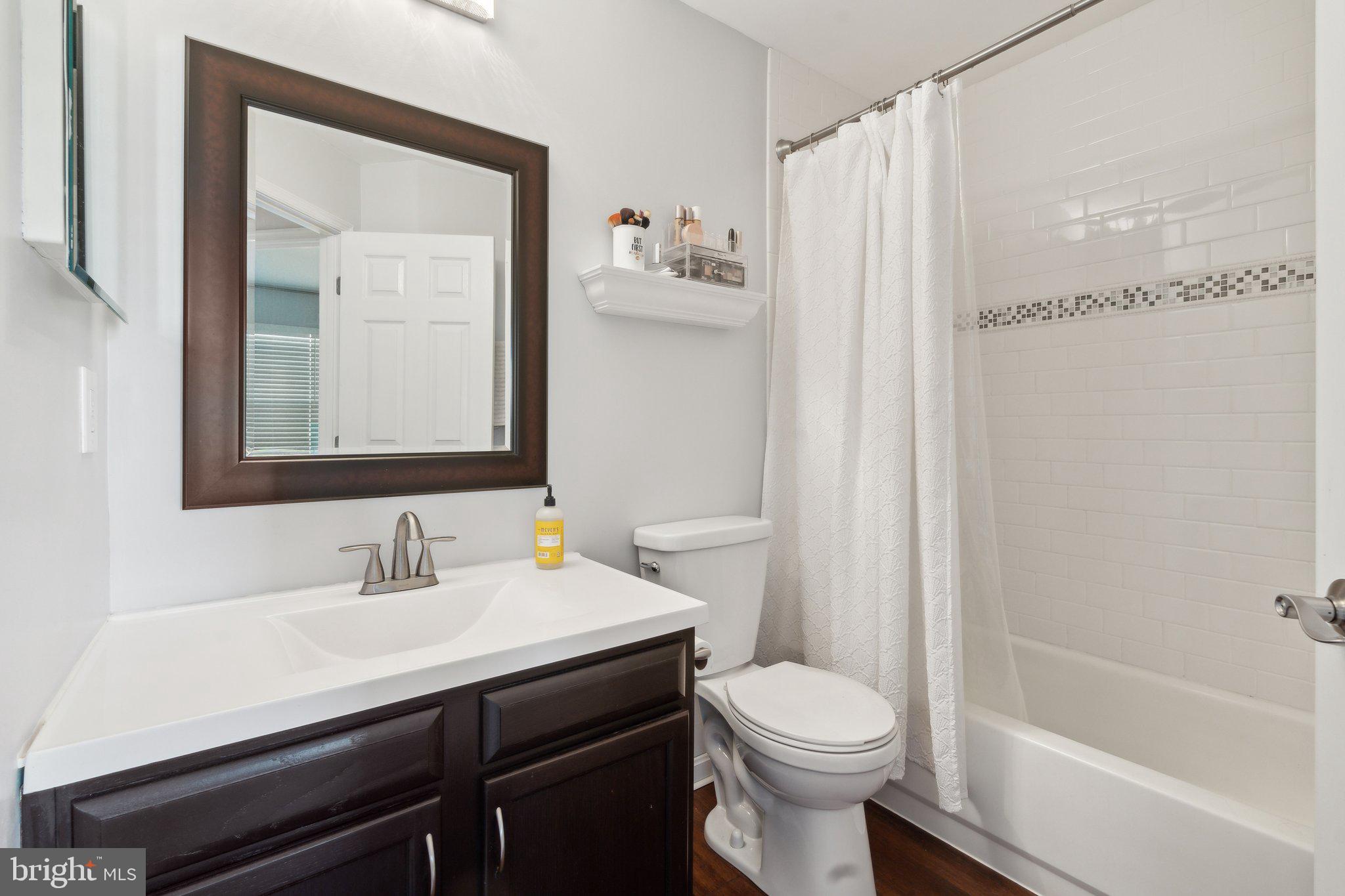 410 McDaniel Drive Purcellville, VA 20132 - Photo 29 of 36 a bathroom with a sink a toilet and shower curtain