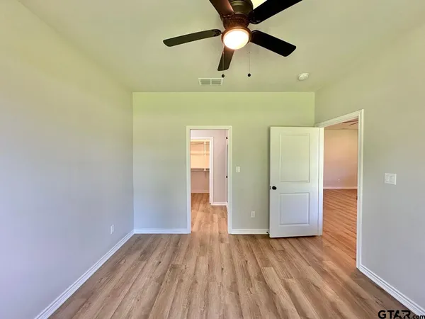 a bathroom with a glass door shower and a toilet