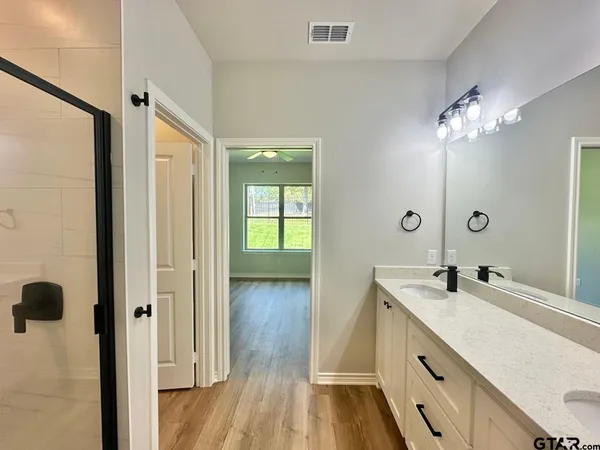 a bathroom with a double vanity sink and mirror