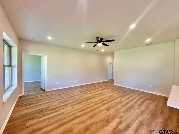 a kitchen with refrigerator and cabinets
