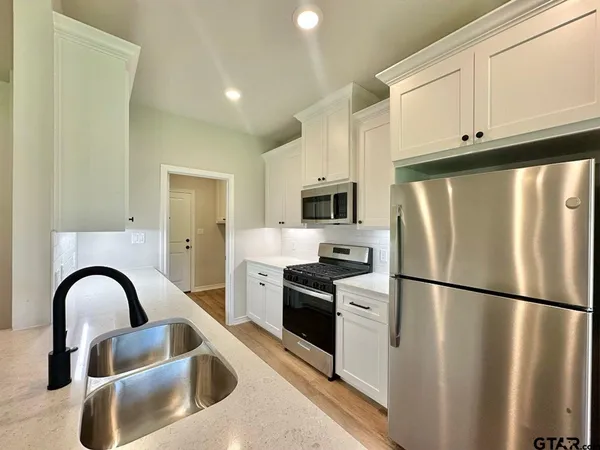 a kitchen with a refrigerator and a sink