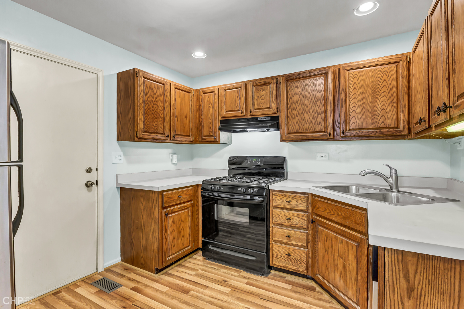 2621 College Hill Circle, Unit 63 Schaumburg, IL 60173 - Photo 8 of 21 a kitchen with stainless steel appliances granite countertop wooden cabinets stove top oven and sink