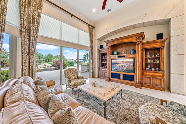 a living room with furniture a rug and a large window