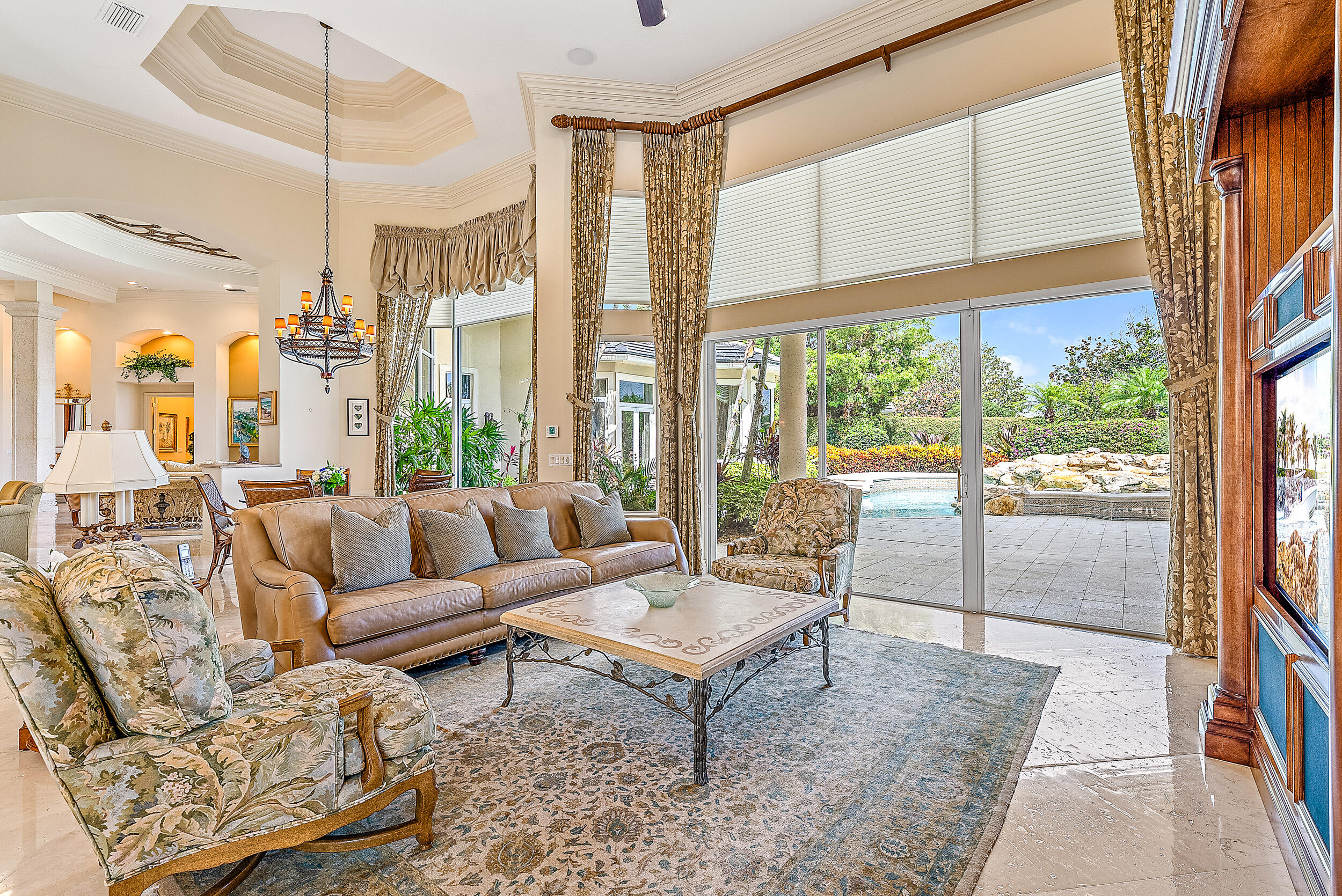 12049 Intercoastal Terrace Jupiter, FL 33469 - Photo 13 of 56 a living room with furniture and a floor to ceiling window