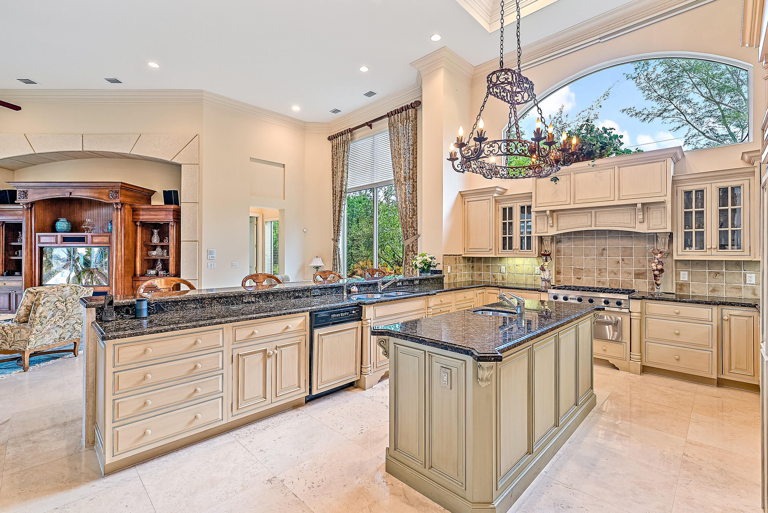 12049 Intercoastal Terrace Jupiter, FL 33469 - Photo 16 of 56 a kitchen with stainless steel appliances granite countertop a stove a sink and a refrigerator