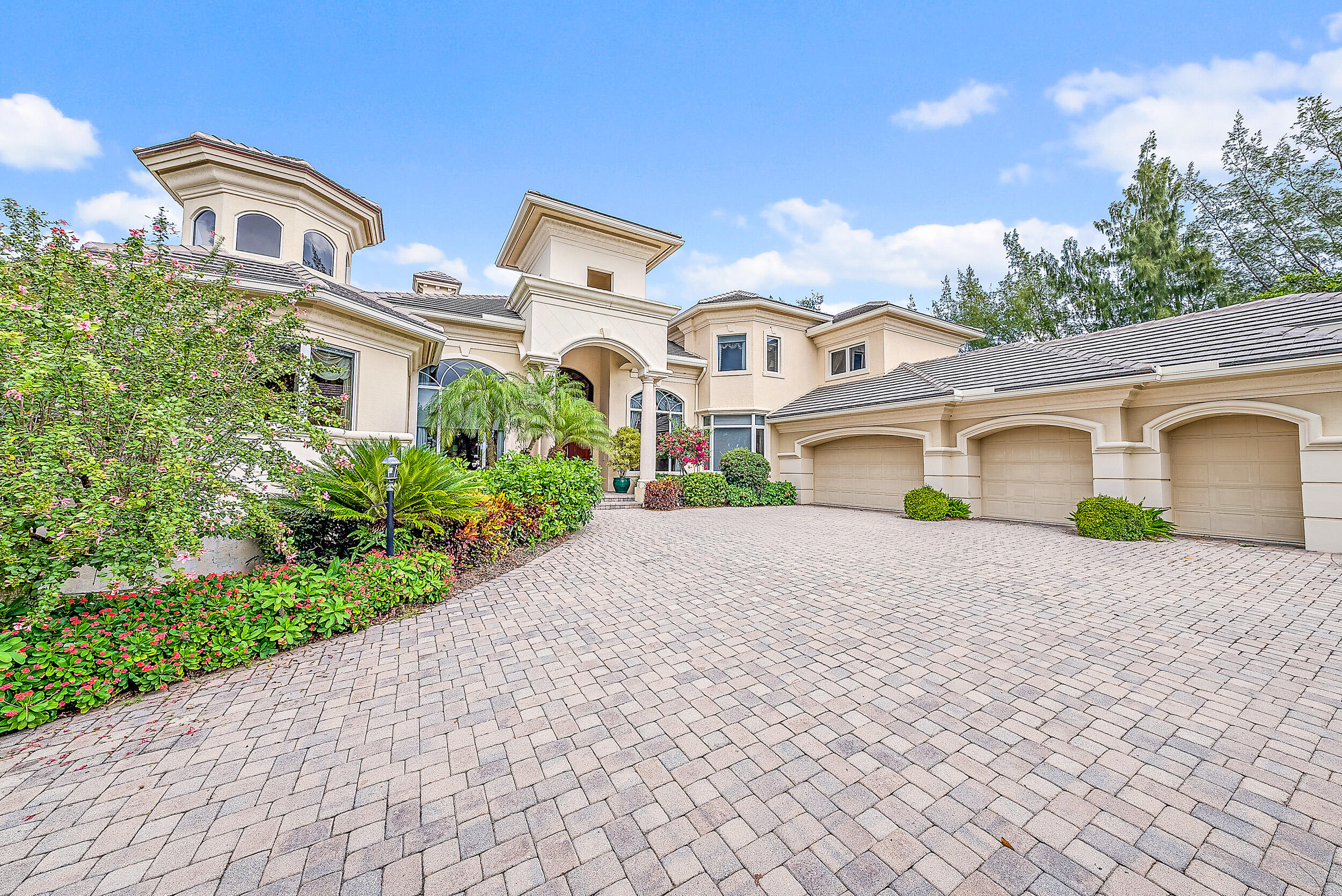 12049 Intercoastal Terrace Jupiter, FL 33469 - Photo 2 of 56 a front view of a house with a yard and garage