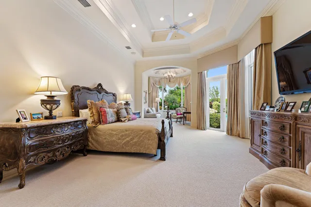 a bedroom with furniture and a flat screen tv