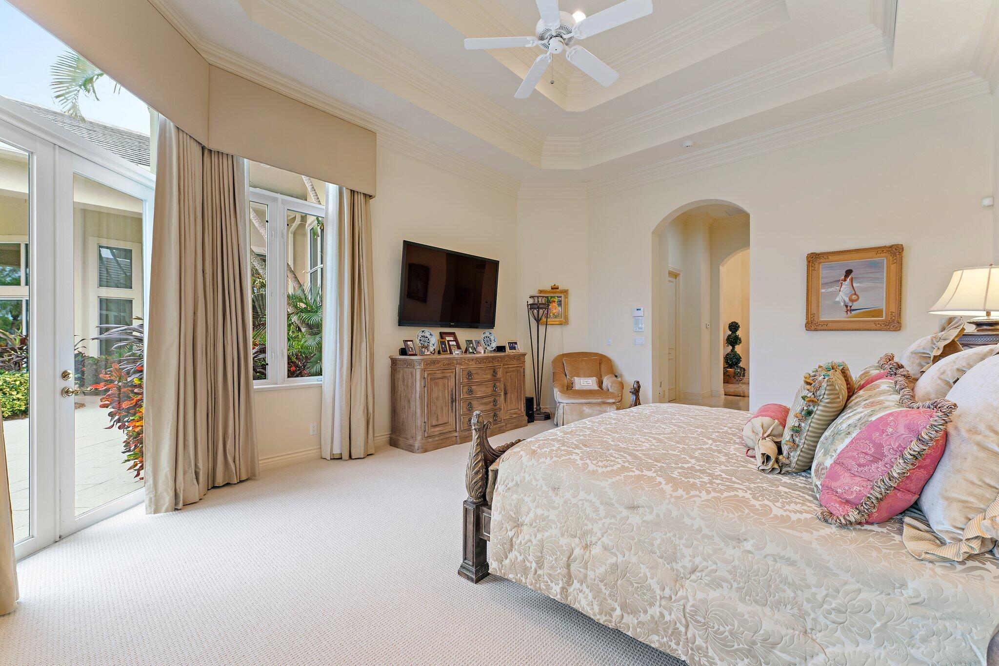 12049 Intercoastal Terrace Jupiter, FL 33469 - Photo 26 of 56 a bedroom with a bed and a flat screen tv