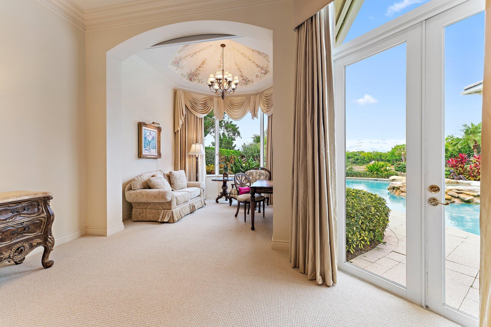 12049 Intercoastal Terrace Jupiter, FL 33469 - Photo 27 of 56 a living room with furniture and a chandelier