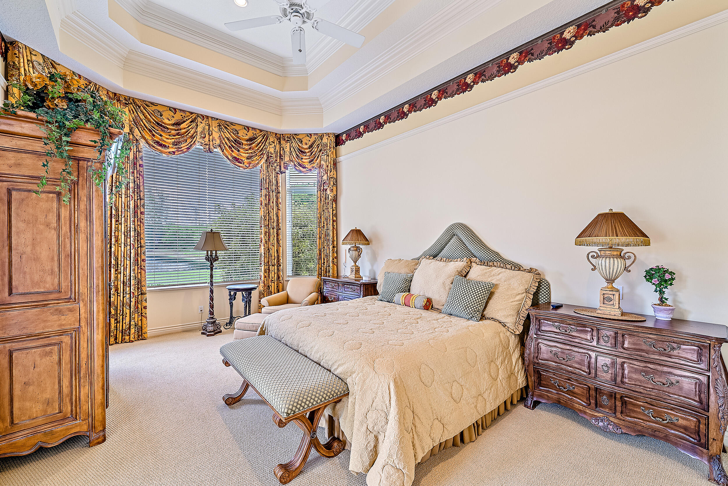 12049 Intercoastal Terrace Jupiter, FL 33469 - Photo 39 of 56 a bedroom with a bed and a chandelier