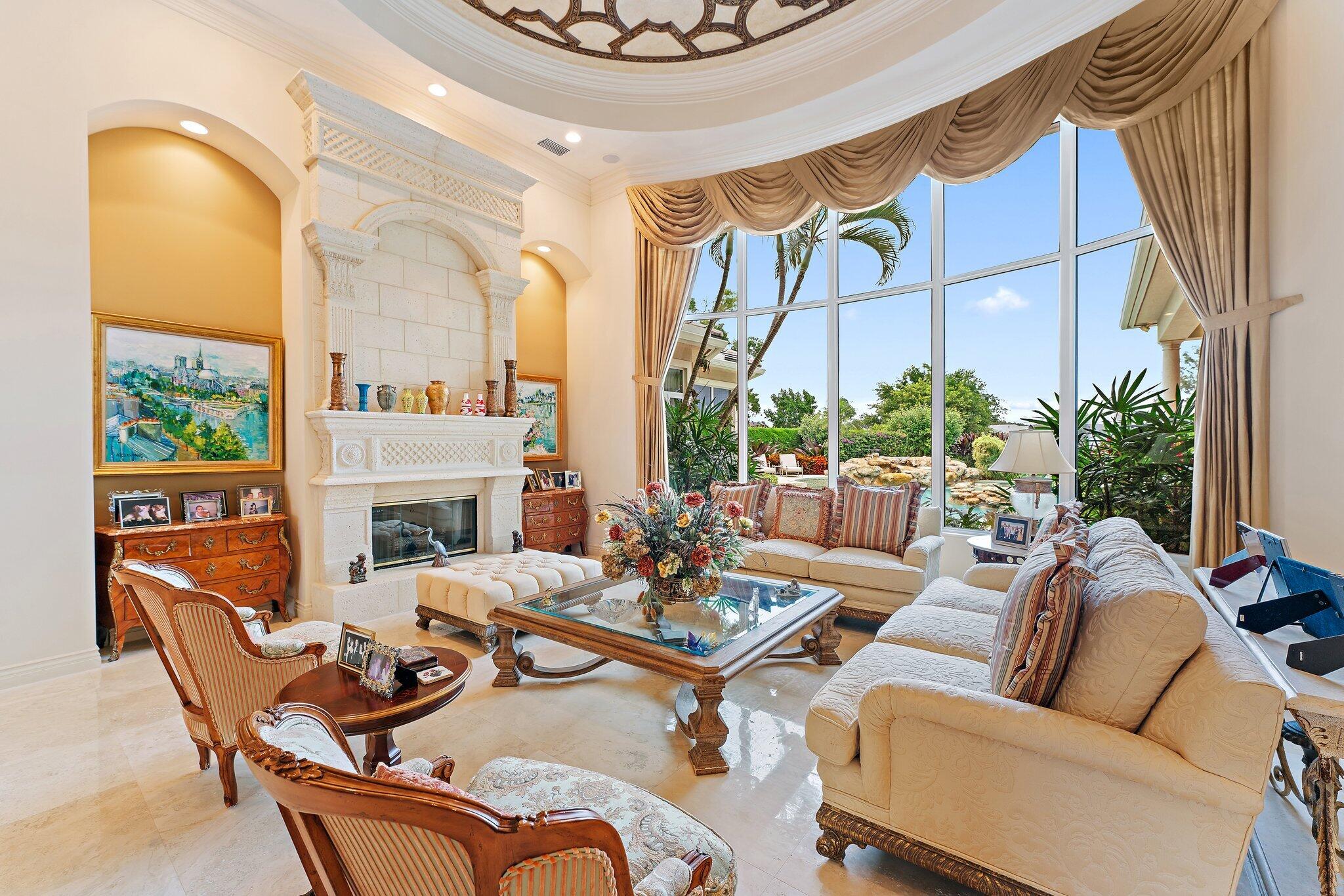 12049 Intercoastal Terrace Jupiter, FL 33469 - Photo 4 of 56 a living room with furniture a fireplace and a potted plant