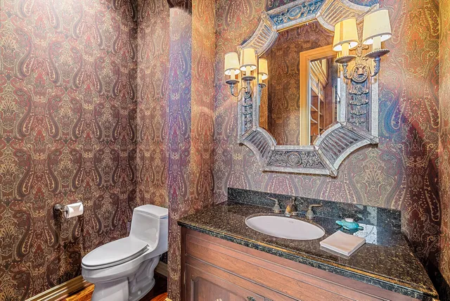 a view of a white house with a big yard and potted plants