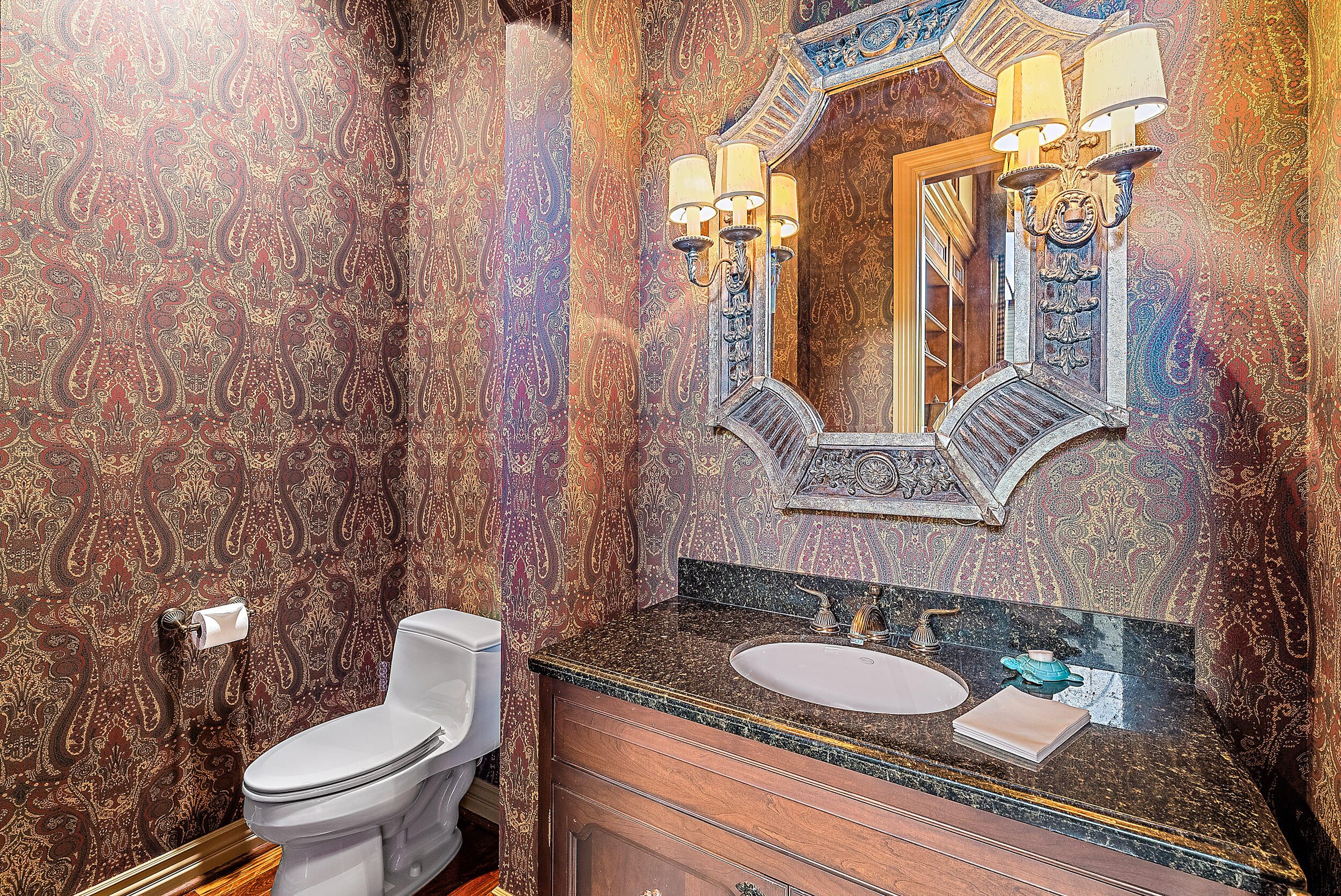 12049 Intercoastal Terrace Jupiter, FL 33469 - Photo 47 of 56 a bathroom with a granite countertop toilet sink and mirror