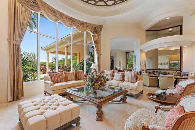 a living room with furniture a rug and a large window