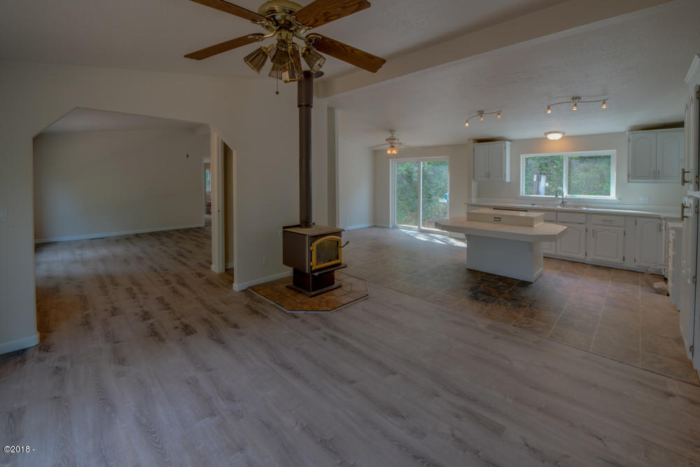 860 Northeast Wagon Road Toledo, OR 97391 - Photo 5 of 24 Living room with wood stove.