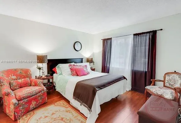 a bedroom with a bed and a couch