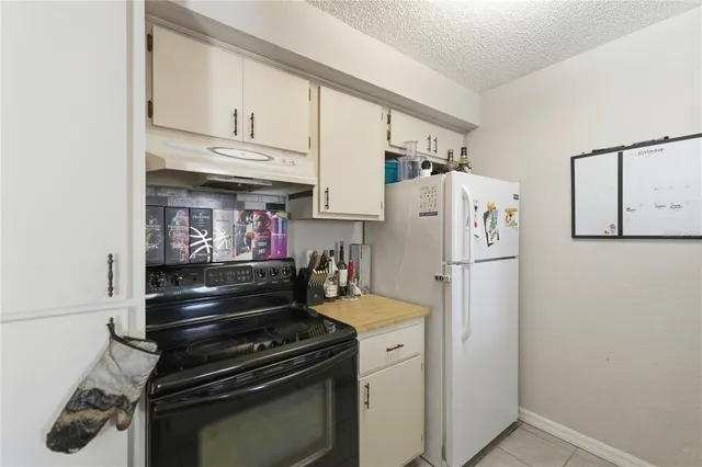 a kitchen with stainless steel appliances a refrigerator and cabinets