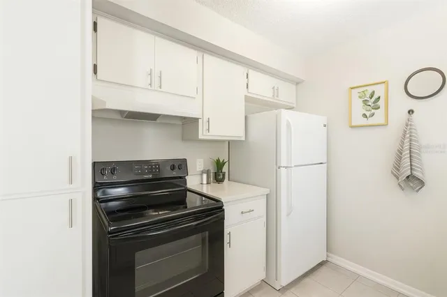 a kitchen with a stove and a refrigerator