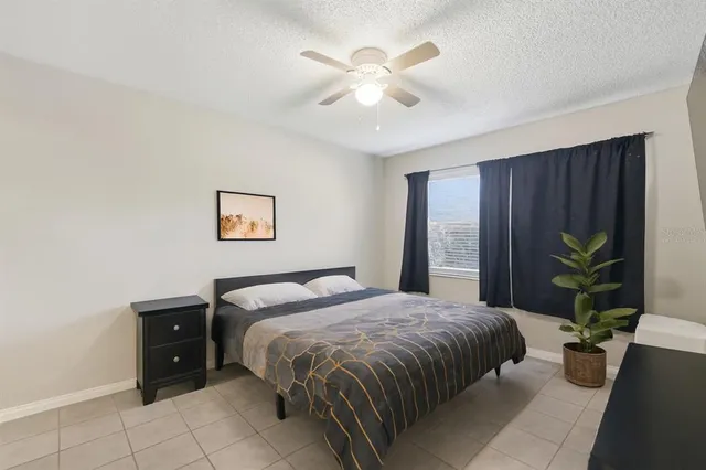 a bedroom with a bed and a potted plant