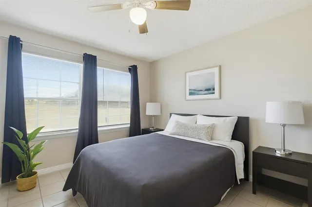 a bedroom with a bed and a potted plant