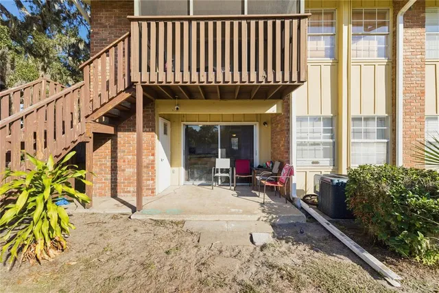 a view of a patio with table and chairs with wooden floor and plants