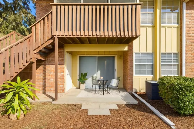 a view of a patio with table and chairs and potted plants