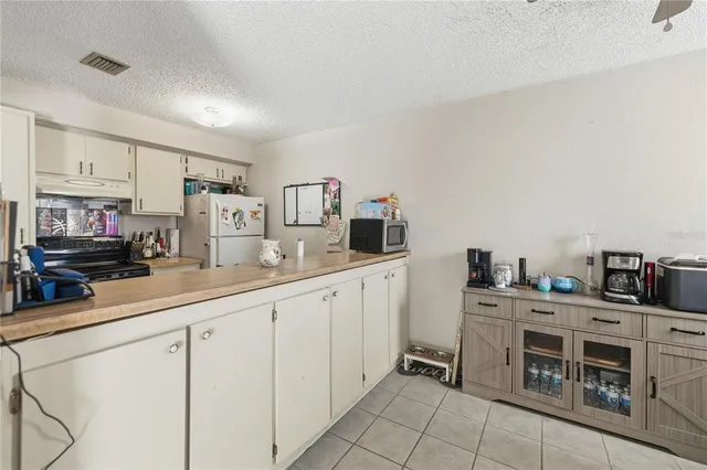 a kitchen with cabinets and chairs