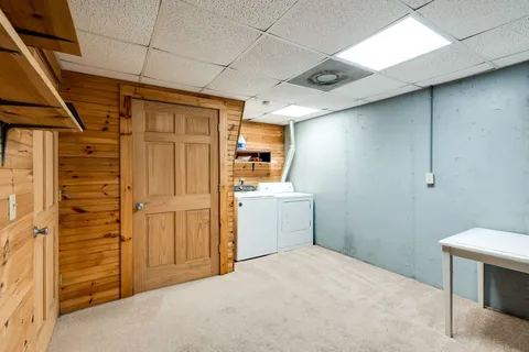a bathroom with a granite countertop toilet and sink
