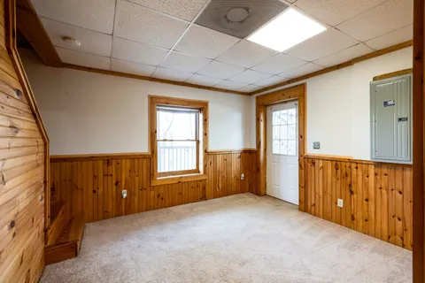 a view of a house with a yard and sitting area
