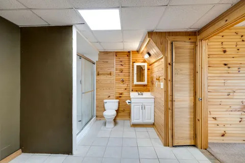 a balcony with wooden floor and yard