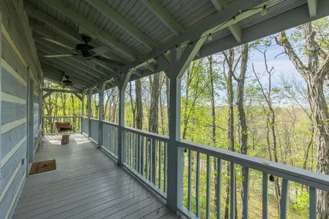 a kitchen with granite countertop a sink cabinets stainless steel appliances and a large window