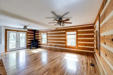 a view of a livingroom with furniture hardwood floor and a ceiling fan