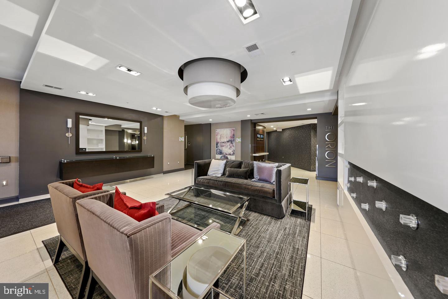 8005 13th Street, Unit 201 Silver Spring, MD 20910 - Photo 25 of 28 a living room with furniture and a flat screen tv