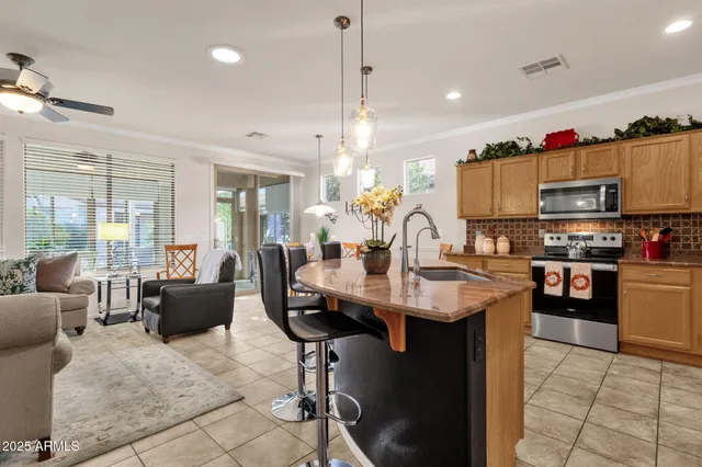 a kitchen with counter space appliances and a view of living room