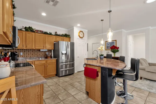 a kitchen with refrigerator and cabinets