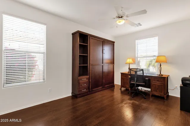 a view of a workspace with furniture and a window
